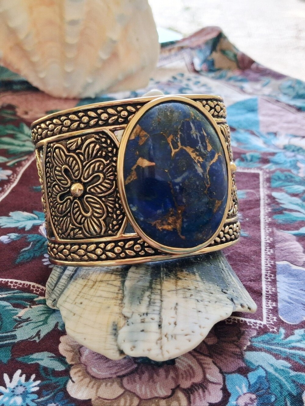 STUDIO BARSE CUFF W/ OVAL GOLD VEINED LAPIS STONE SET IN INTRICATE CARVED BRONZE